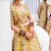 mustard-golden-lehenga-bridal-campaign-full-silhouette-gota-zardozi-hand-embroidered-hammad-bespoke-official.webp golden bridal lehenga choli close-up Zardozi floral sleeve Master Artisan embroidery Hammad Bespoke Official