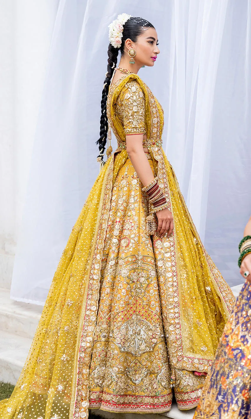 mustard-golden-lehenga-bridal-campaign-full-silhouette-gota-zardozi-hand-embroidered-hammad-bespoke-official.webp yellow bridal lehenga side view full farshi sweep Gota border Resham motifs Hammad Bespoke Official