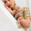 mustard-golden-lehenga-bridal-campaign-full-silhouette-gota-zardozi-hand-embroidered-hammad-bespoke-official.webp gold lehenga for bride three-quarter front Zardozi Resham floral bodice mustard Hammad Bespoke Official