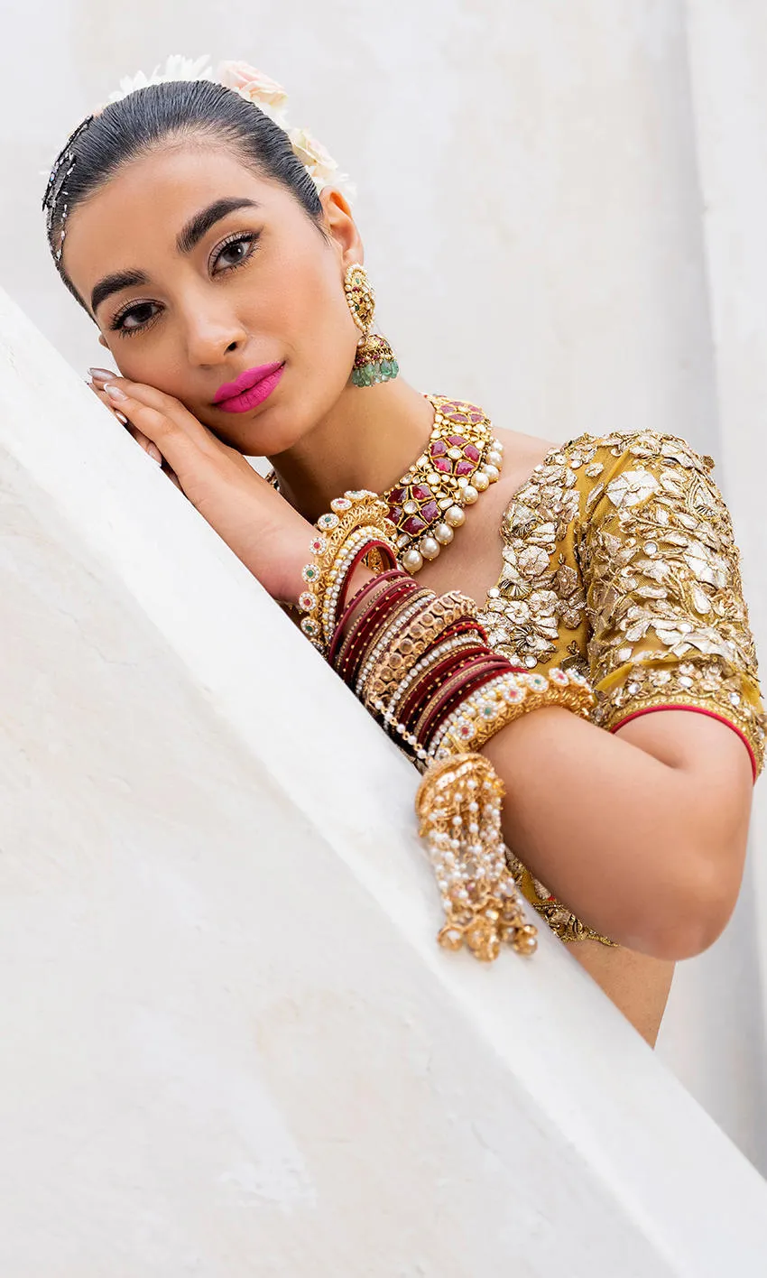 mustard-golden-lehenga-bridal-campaign-full-silhouette-gota-zardozi-hand-embroidered-hammad-bespoke-official.webp gold lehenga for bride three-quarter front Zardozi Resham floral bodice mustard Hammad Bespoke Official