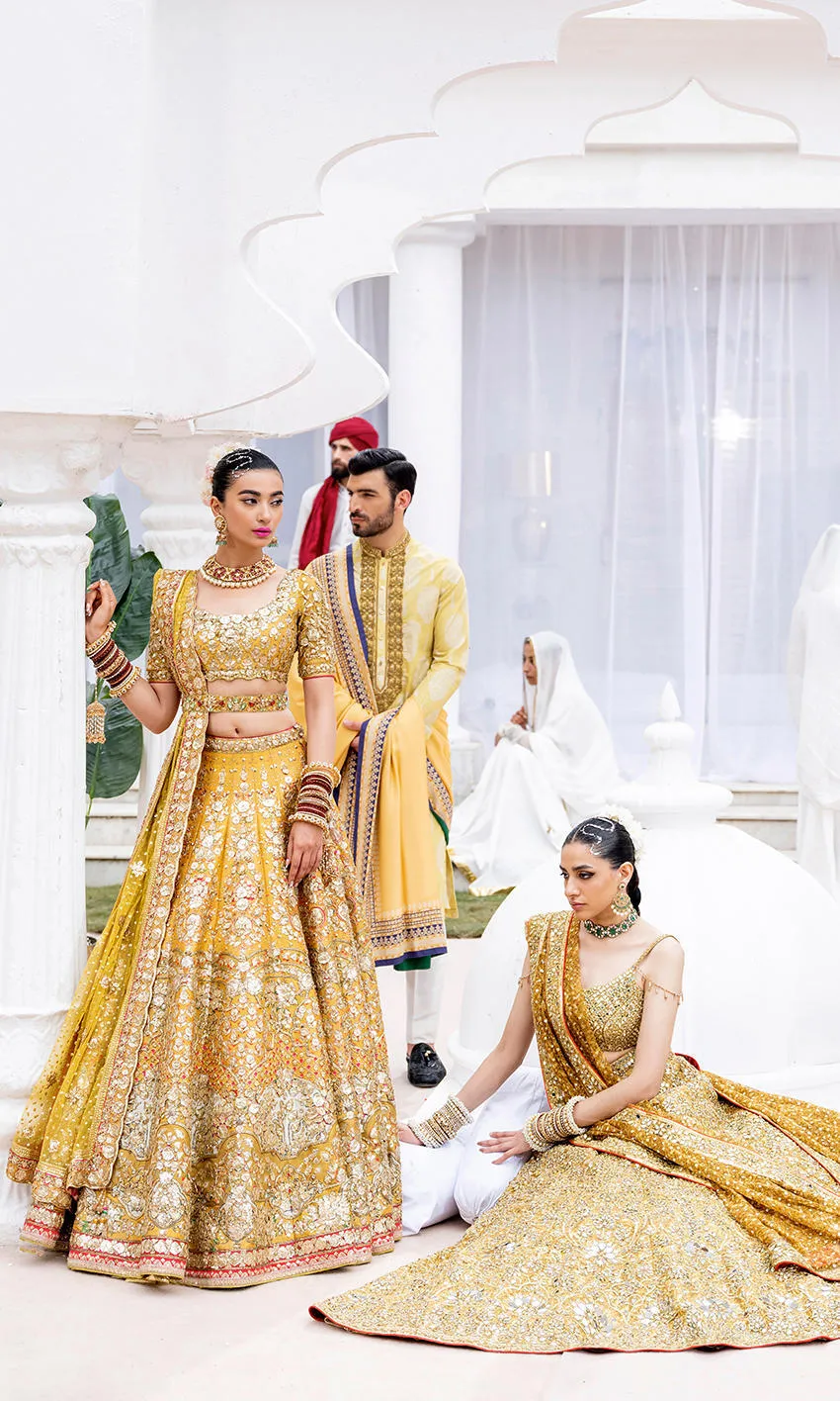 mustard-golden-lehenga-bridal-campaign-full-silhouette-gota-zardozi-hand-embroidered-hammad-bespoke-official.webp golden lehenga bridal standing seated duo Gota Resham embroidery barat Hammad Bespoke Official