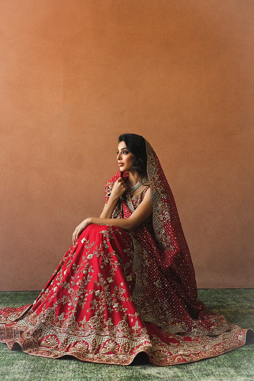 Silk bridal lehenga with train — candy red raw silk, peacock border, Zardozi embroidery, Multan Atelier Hammad Bespoke Official
