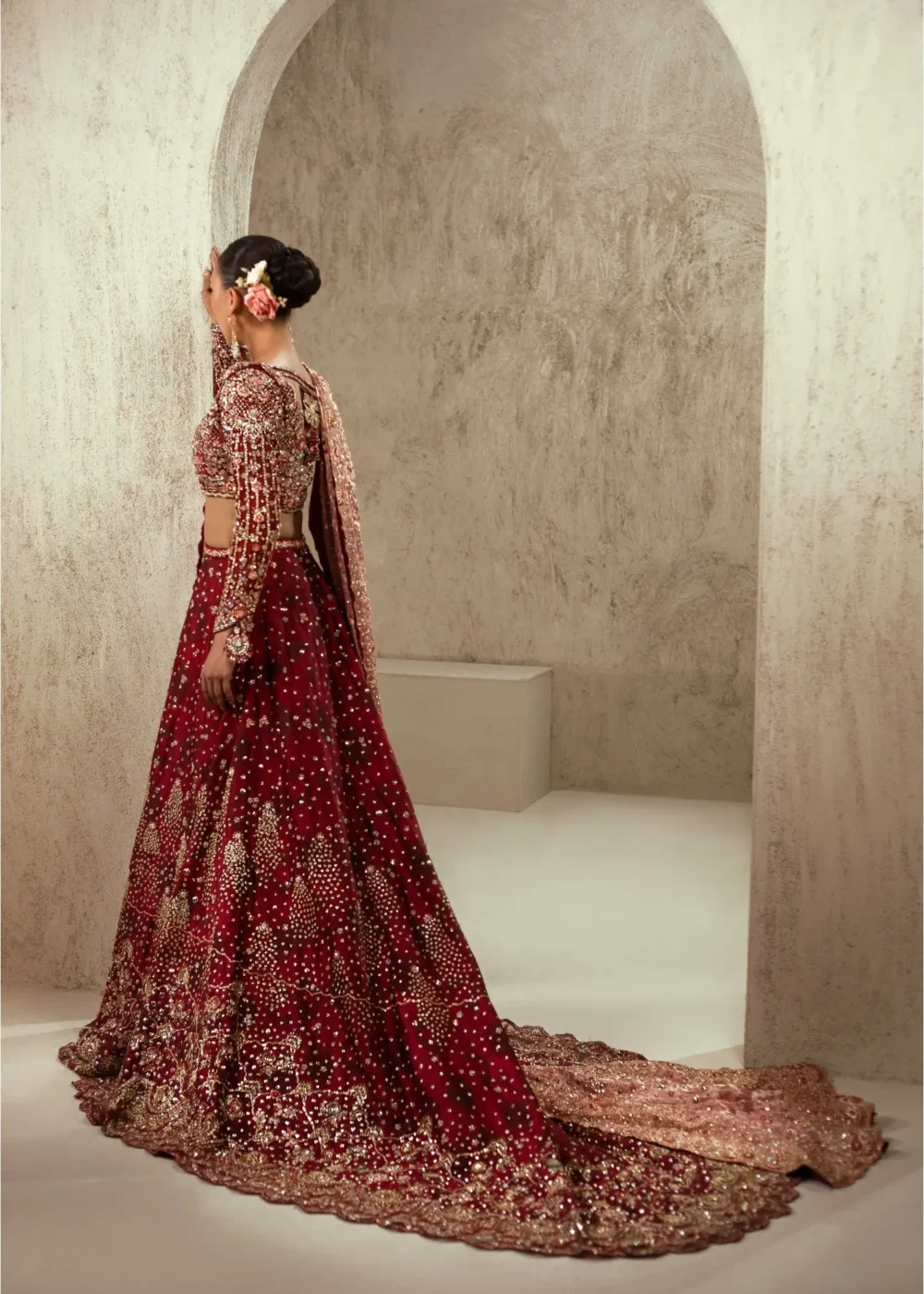 Pakistani maroon velvet bridal lehenga with rose-gold Nakshi dupatta draped — Hammad Bespoke Official Barat couture