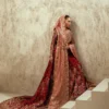 Maroon velvet bridal lehenga with blush rose dupatta and gold Zardozi train — Hammad Bespoke Official Multan Atelier