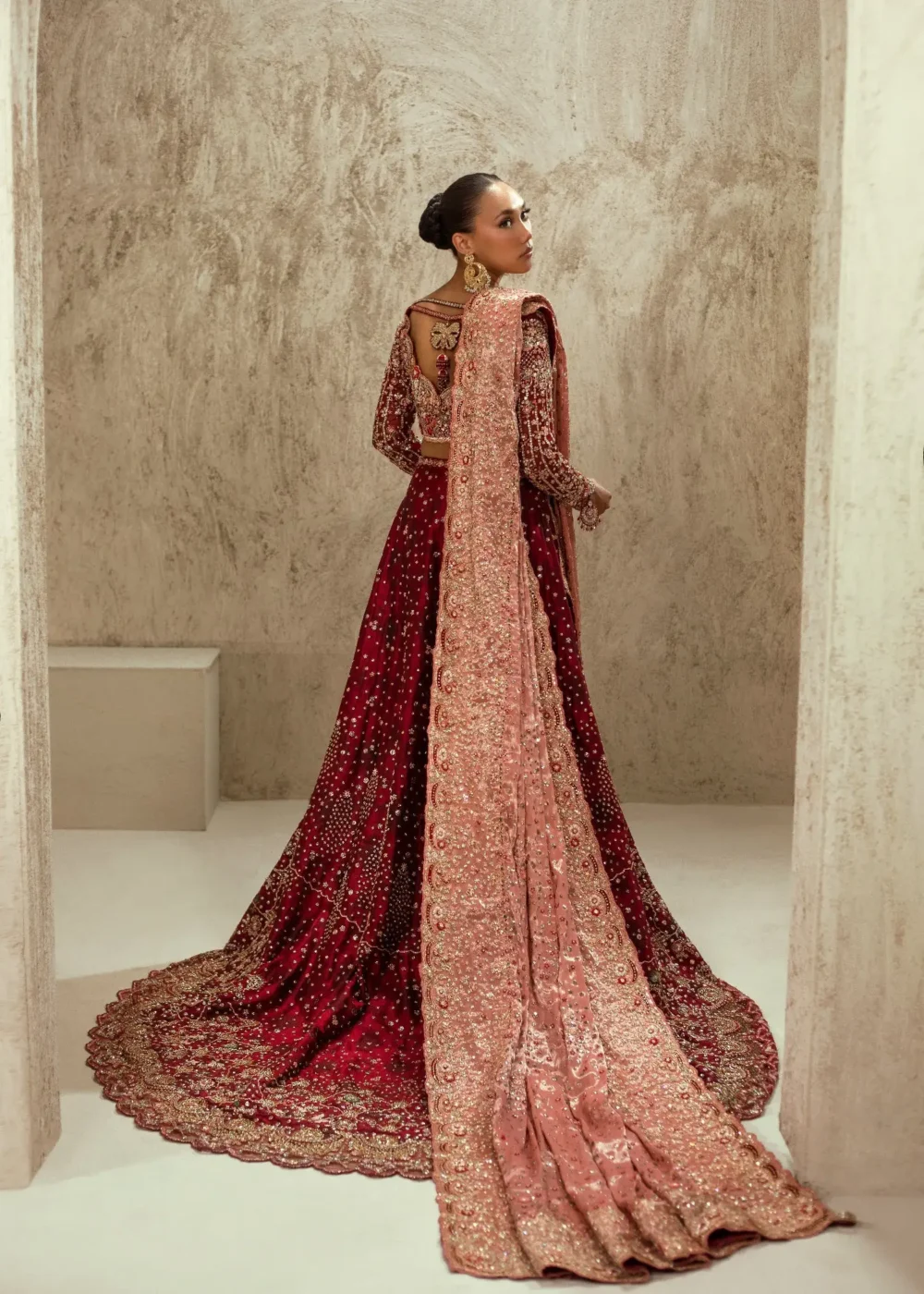 Full-length maroon velvet bridal lehenga with gold Zardozi border and cathedral train — Hammad Bespoke Official