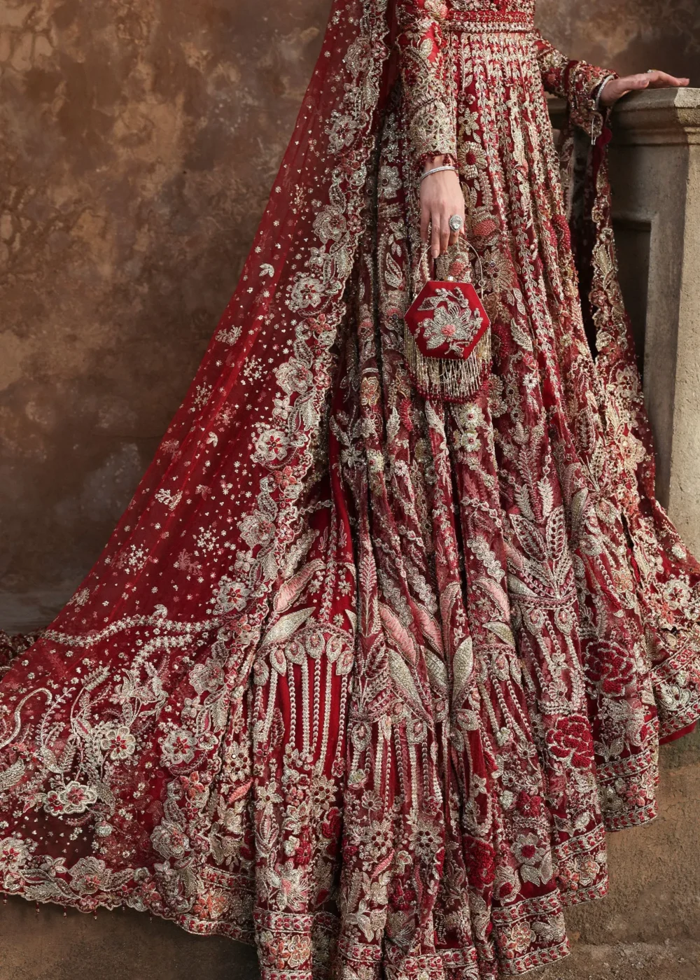 Skirt detail deep red net lehenga with Tilla borders, Nakshi floral panels, bridal clutch — Hammad Bespoke Official