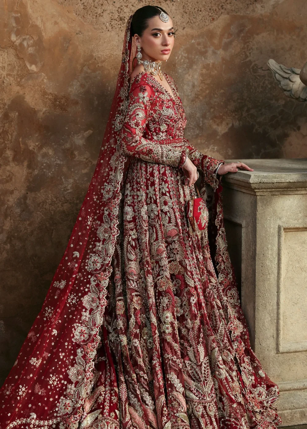 Side profile red net bridal lehenga full length — dense gold Zardozi floral motifs, Hammad Bespoke Official Multan