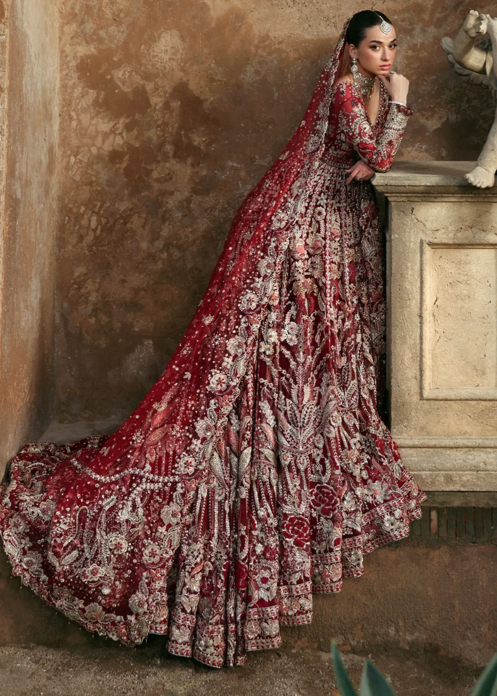 Three-quarter back view deep red net bridal lehenga with full train — Zardozi and Nakshi, Hammad Bespoke Official