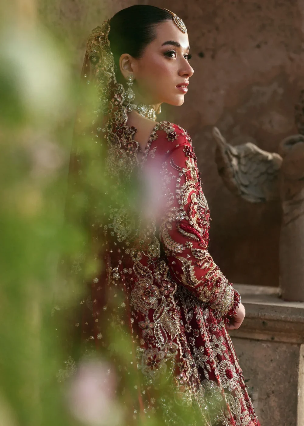 Close profile bride in red net lehenga — gold Zardozi bodice, embroidered net dupatta, Hammad Bespoke Official Atelier