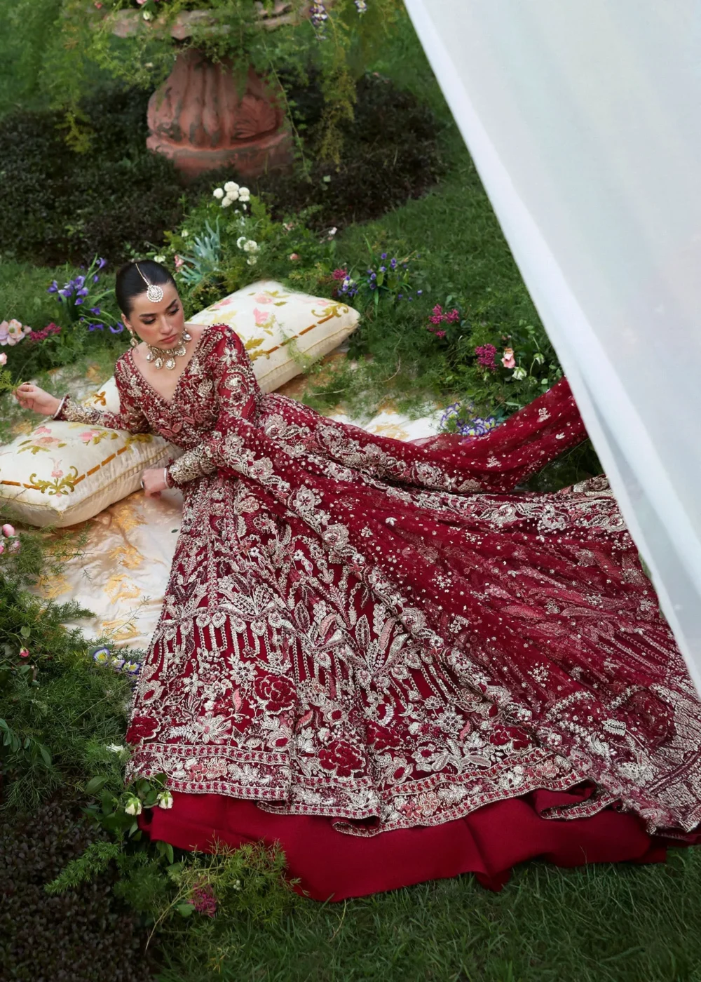 Aerial view red net bridal lehenga train with heavy Zardozi embellishment — Barat couture, Hammad Bespoke Official