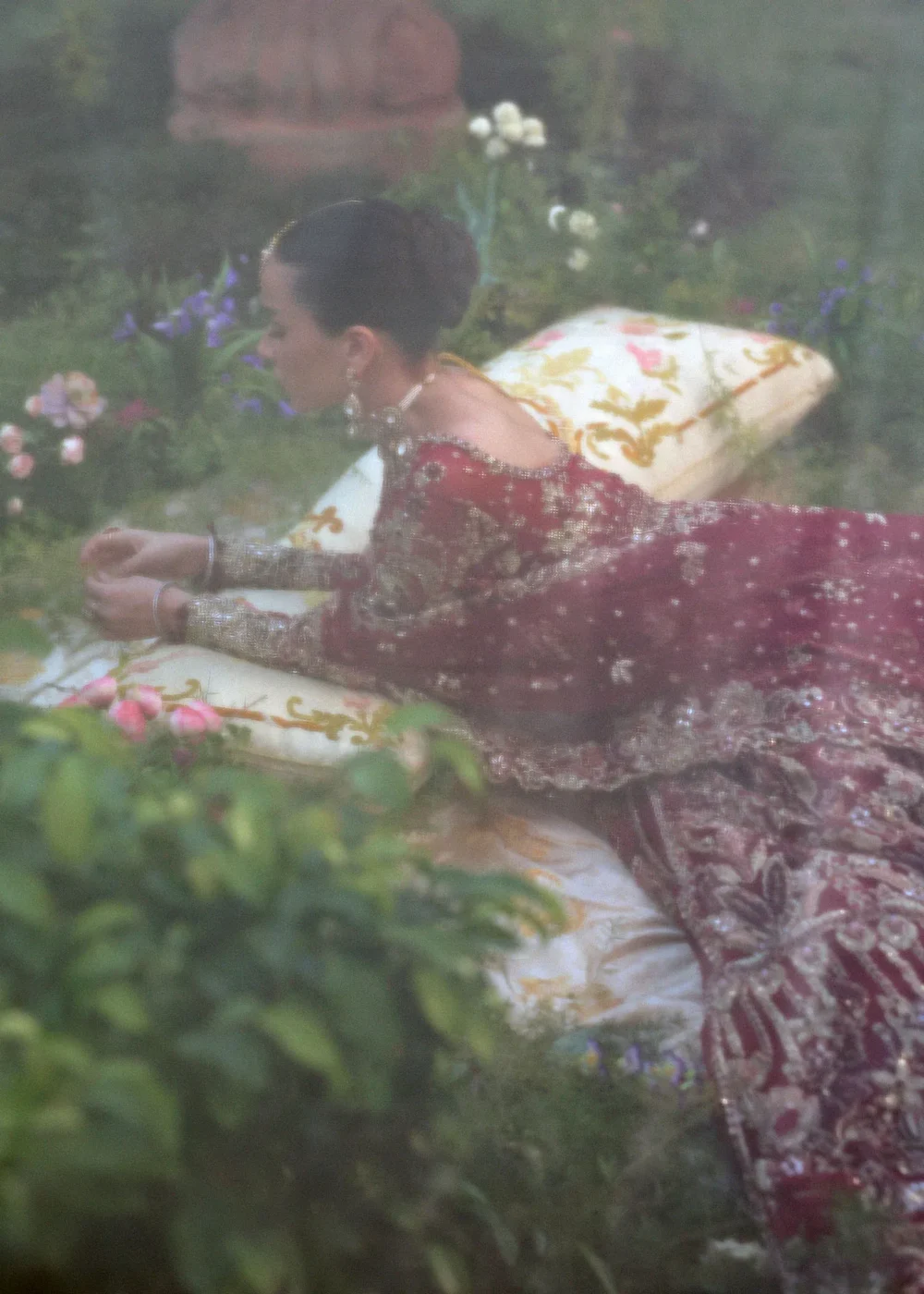 Dreamy soft-focus bridal portrait — crimson net lehenga with gold embroidery, Hammad Bespoke Official Multan Atelier