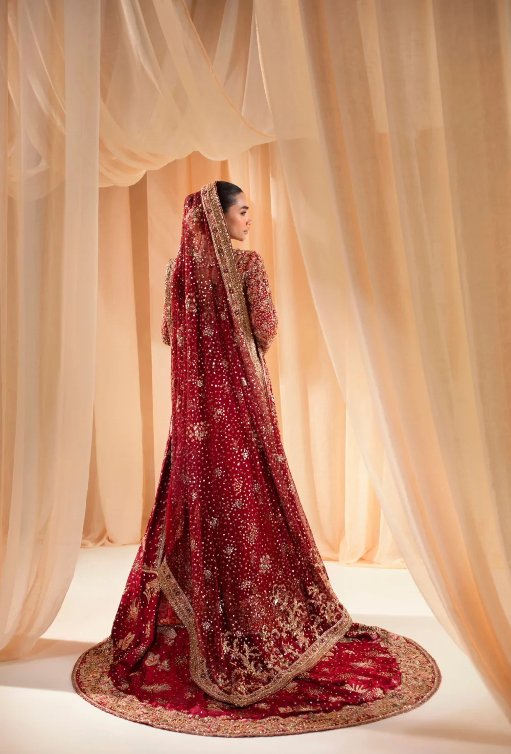 Pakistani red bridal lehenga back view — full cathedral train with gold Zardozi hem border — HBO Multan Atelier