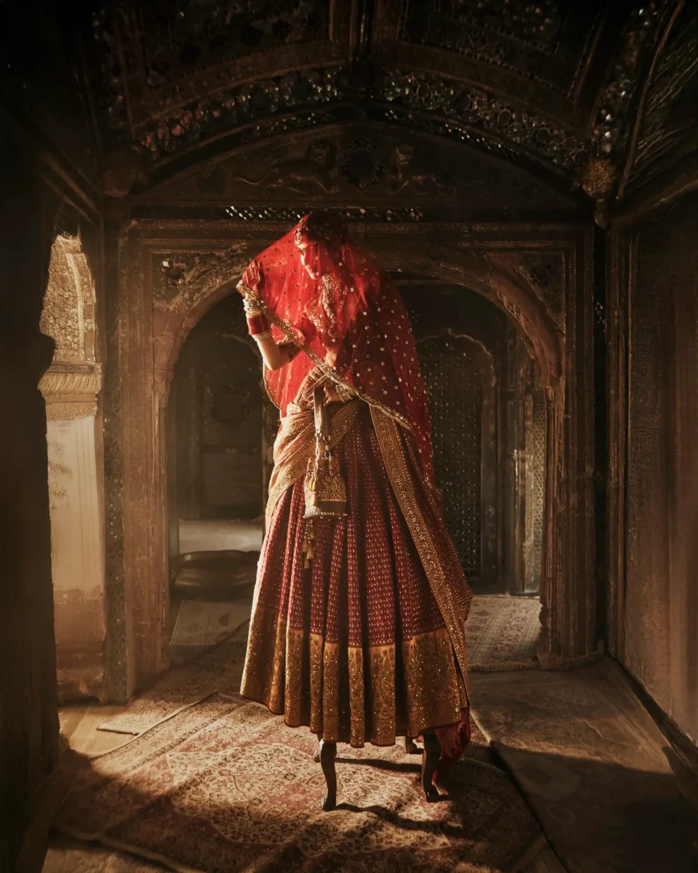 Zarin Rosha – dramatic candlelit palace setting | red raw silk Pakistani bridal lehenga USA