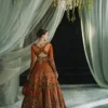 Back view orange organza bridal lehenga showing cross-back choli and 240-inch flared skirt — Hammad Bespoke Official