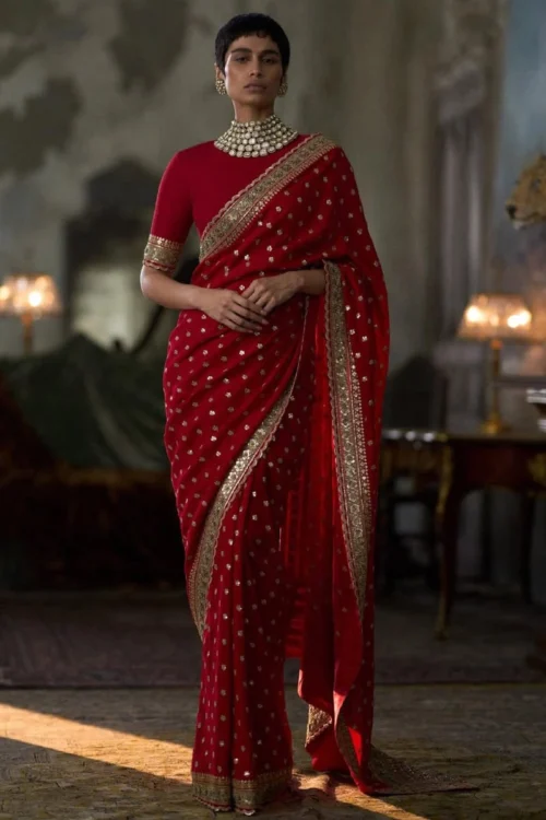 red-embroidered-georgette-saree-gold-border-scalloped-kaamdani-bootis-custom-blouse-hammad-bespoke-official.webp red embroidered georgette saree gold border scalloped kaamdani bootis custom blouse Hammad Bespoke Official